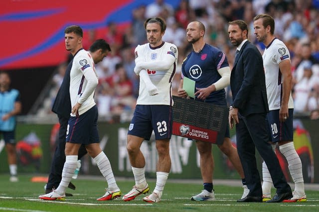 England substitutes Mason Mount (left), Jack Grealish (centre) and Harry Kane prepare to come on