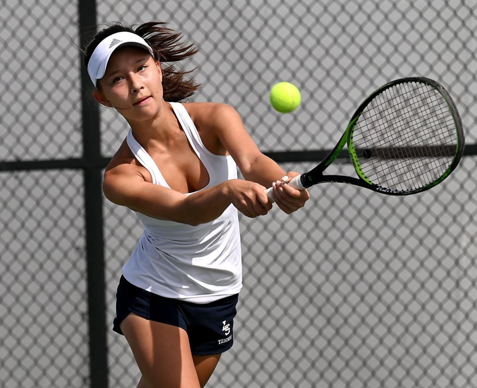 Lincoln-Sudbury's Lia Swire at third singles backhands  during her match against Lexington at MIT in MIAA Division 1 girls tennis state championship match at MIT, June 18, 2022. 