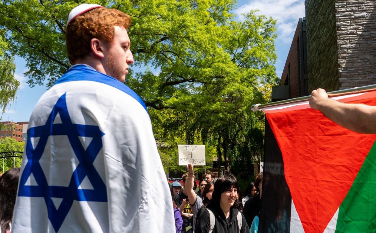 A pro-Israel counter-protester stands by a pro-Palestinian Jewish protester on April 25, 2024 at Temple University in Philadelphia.