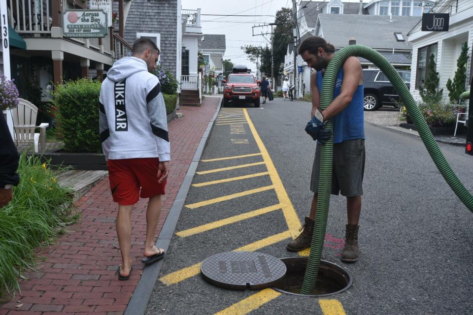 Dylan Kaeselau of James Roderick Rubbish and Septic Service pumps wastewater into a tanker Friday morning on Commercial Street in Provincetown. Repairs to the public vacuum sewer system continued on Friday after a storm damaged equipment, town officials said.