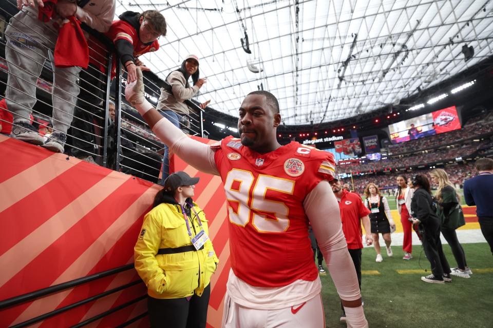 Kansas City's Chris Jones shakes hands with fans before Super Bowl 58.