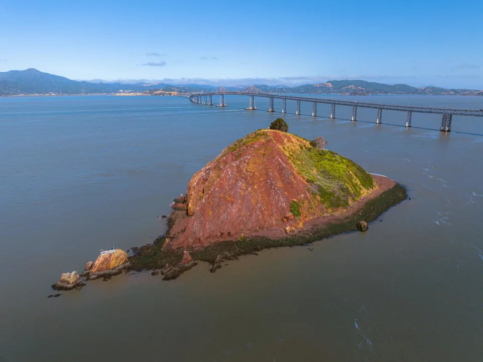 <span>Red Rock Island sits near the Richmond-San Rafael Bridge.</span><span>Photograph: Aerial Canvas</span>