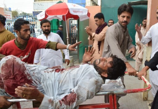 An injured Pakistani man is brought to a hospital in Quetta on July 13, 2018 following a bomb blast at an election rally