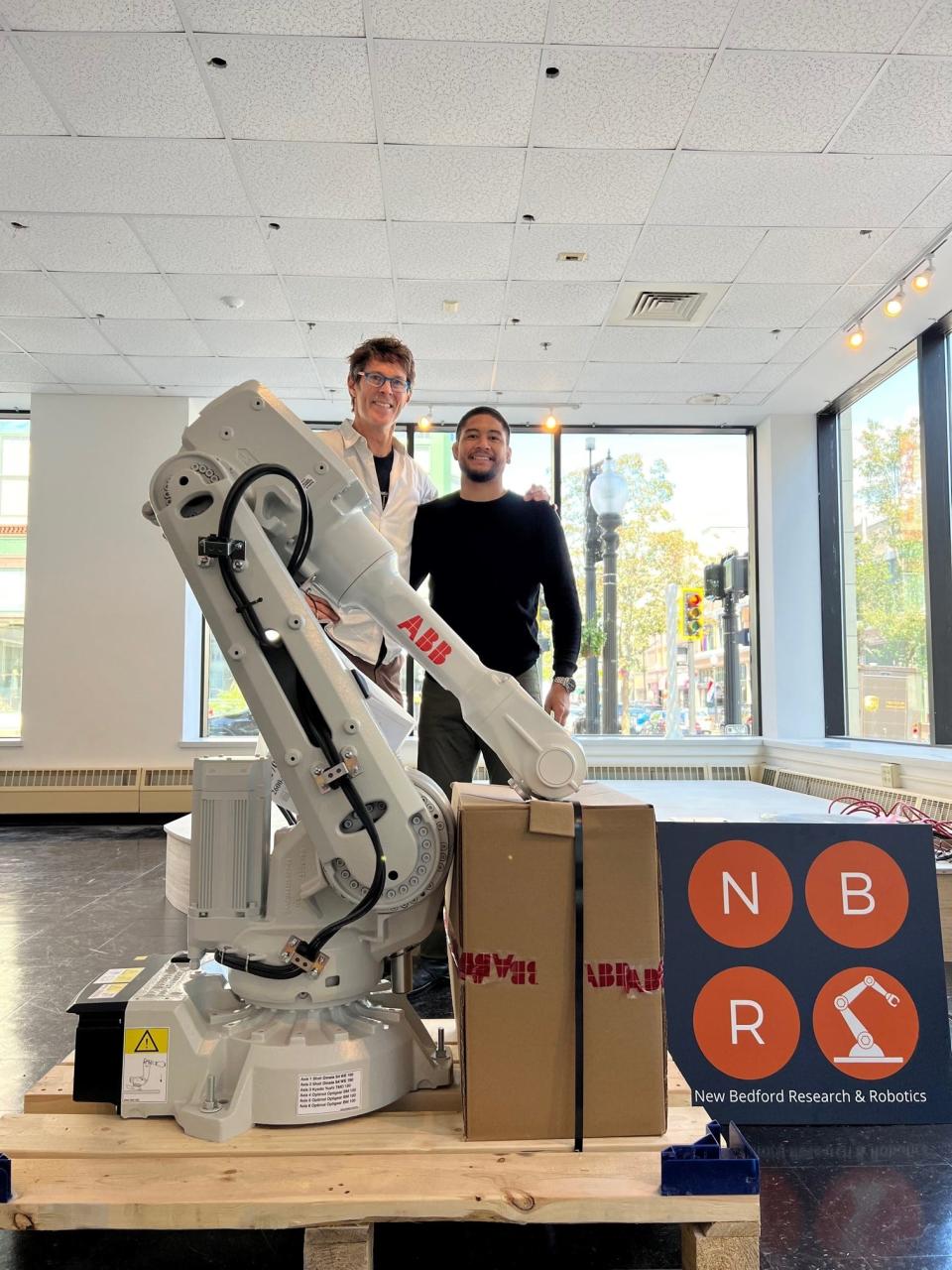 New Bedford Research & Robotics founder and Executive Director Mark Parsons moves a robot into the Swain Gallery at the Star Store on Union Street in downtown New Bedford for 3D printing and other projects.