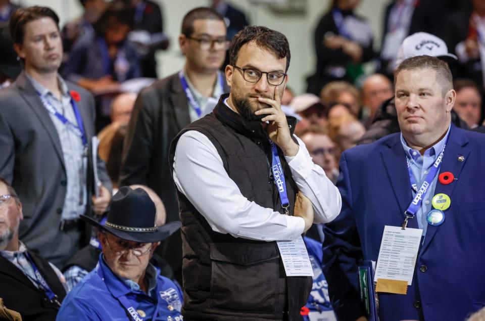 David Parker, centre, founder of Take Back Alberta, looks on as delegates debate resolutions at the United Conservative Party annual general meeting in Calgary, on Nov. 4.