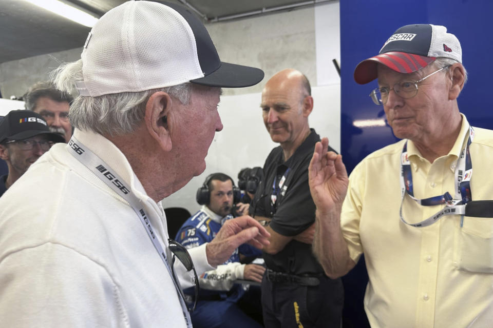 NASCAR chairman Jim France, right, speaks to Hall of Famer Hershel McGriff inside Garage 56 at the 24 Hours of Le Mans in Le Mans, France, Wednesday, June 7, 2023. McGriff twice ran the endurance race as part of NASCAR earlier efforts to compete in the prestigious sports car race. (AP Photo/Jenna Fryer)
