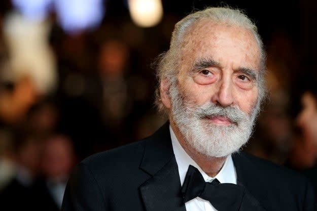 Elderly gentleman with a white beard in a black tuxedo, looking thoughtful