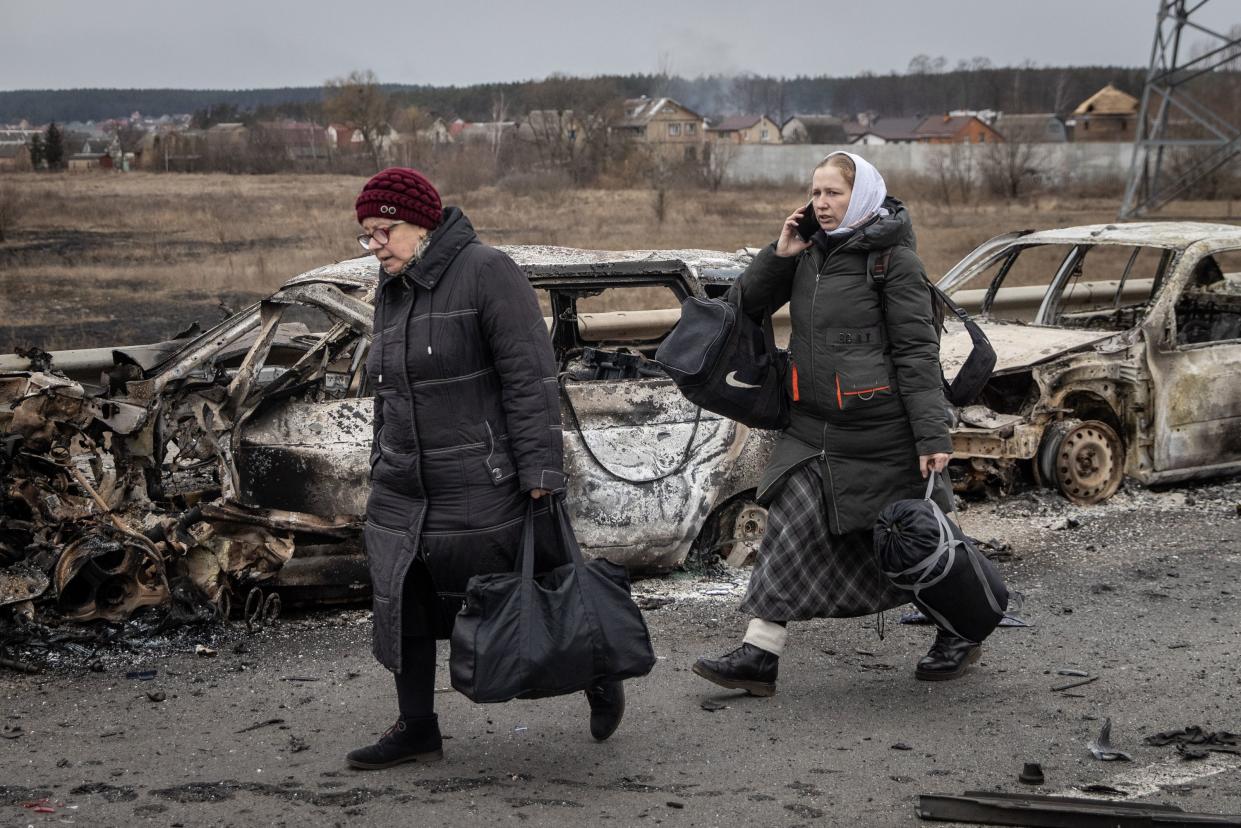 Residents of Irpin flee heavy fighting via a destroyed bridge as Russian forces entered the city on March 07, 2022, in Irpin, Ukraine.