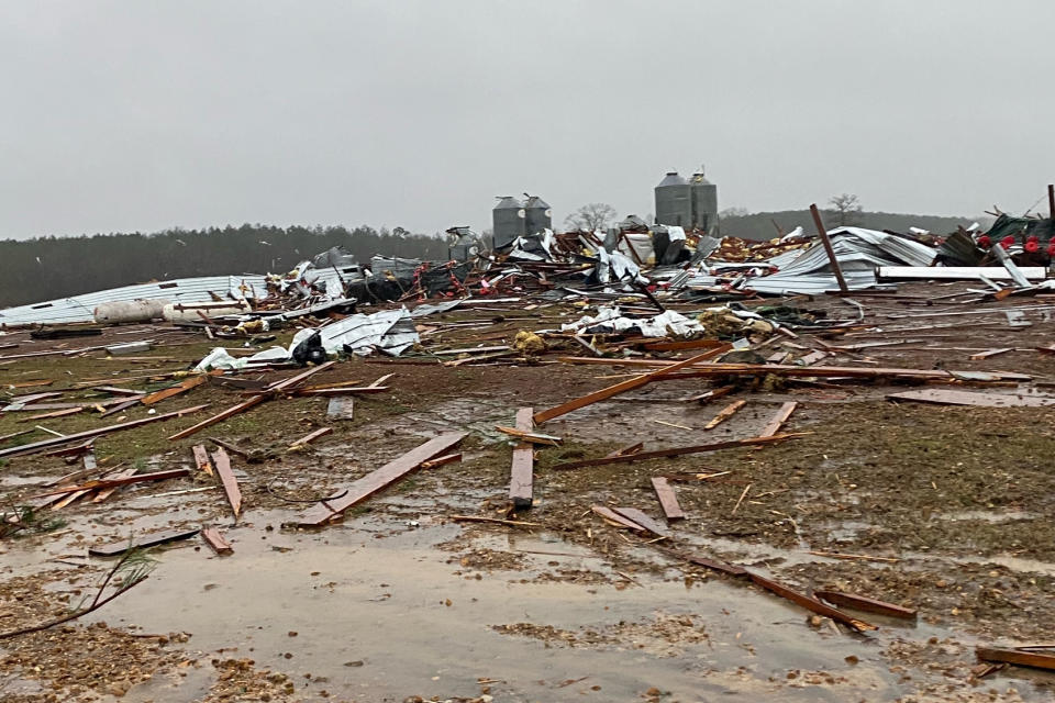 Rankin County authorities and first responders inspect the damage at a poultry farm in Pelahatchie, Miss.