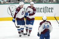 Colorado Avalanche's Josh Manson (42), Brandon Duhaime (12) and Samuel Girard (49) celebrate a goal by Duhaime against the Dallas Stars during the third period in Game 2 of an NHL hockey Stanley Cup second-round playoff series Thursday, May 9, 2024. (AP Photo/Tony Gutierrez)
