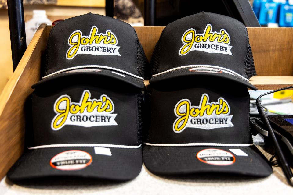 John's Grocery hats are seen next to the cash register, Thursday, Nov. 9, 2023, at John's Grocery in Iowa City, Iowa.
