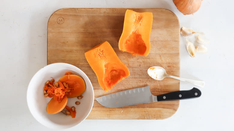 honey nut squash cut in half with knife