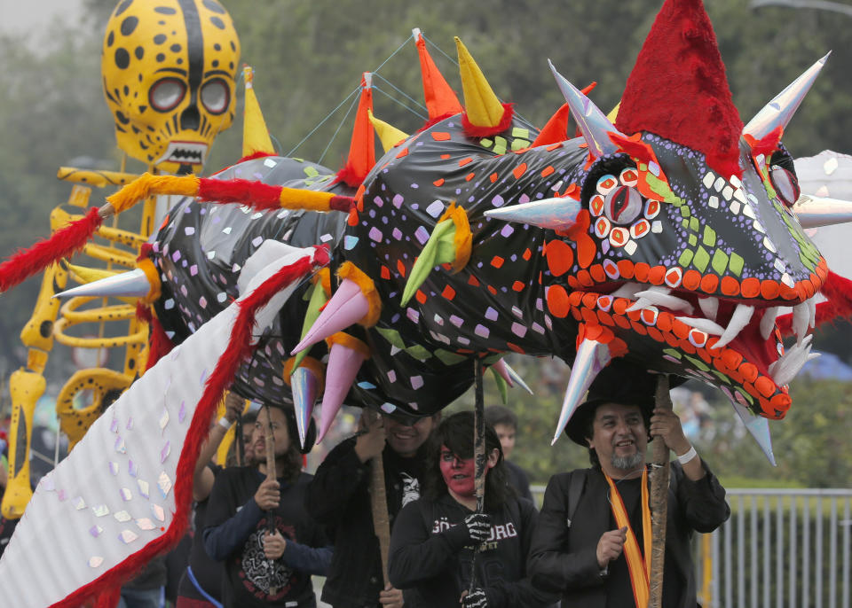 Performers participate in the Day of the Dead parade in Mexico City, Saturday, Nov. 2, 2019. (AP Photo/Ginnette Riquelme)