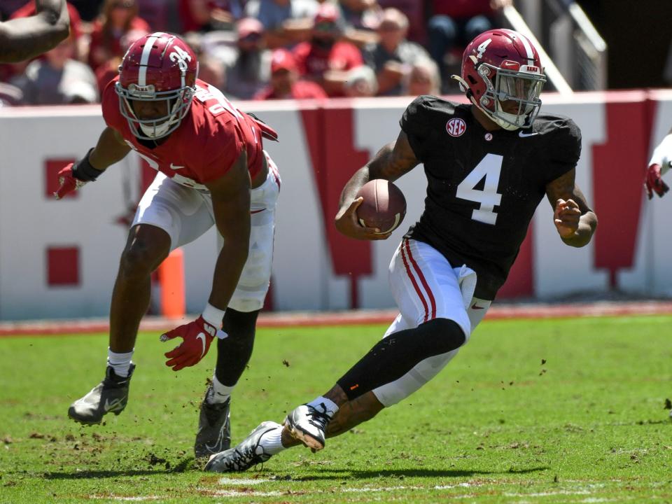 Apr 22, 2023; Tuscaloosa, AL, USA; Crimson team linebacker Quandarrius Robinson (34) can't stop a run by White team quarterback Jalen Milroe (4) during the A-Day game at Bryant-Denny Stadium.
