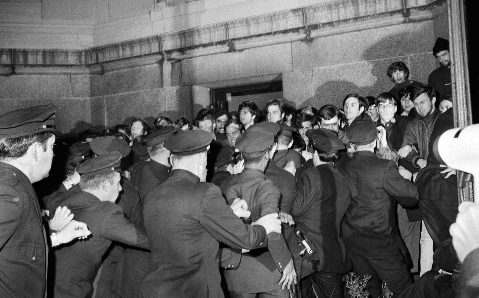 FILE - New York City police rush toward student protesters in the early morning, April 30, 1968, outside Columbia University's Low Memorial Library as they sought to remove demonstrators involved in sit-ins at university buildings. (AP Photo/Dave Pickoff, File)