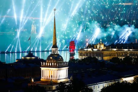 Fireworks are seen over the Admiralty building, the Peter and Paul cathedral and the State Hermitage museum during the festivities marking school graduation in St. Petersburg, Russia June 24, 2018. REUTERS/Anton Vaganov