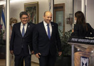 Israeli Prime Minister Naftali Bennett, center, and Honduran President Juan Orlando Hernandez, left, at the prime minister's office, in Jerusalem, Thursday, June 24, 2021. (Heidi Levine/Pool via AP).