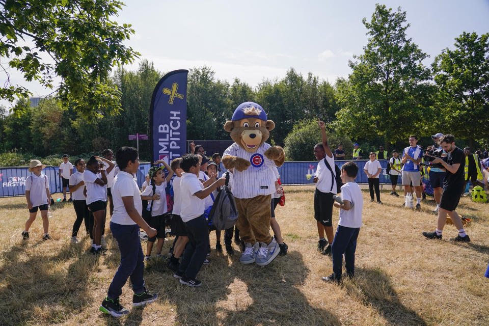 Clark, Chicago Cubs mascot welcomes school kids at the MLB First Pitch Festival, at the Queen Elizabeth Olympic Park, in London, Thursday, June 22, 2023. Britain's relative success at the World Baseball Classic and the upcoming series between the Chicago Cubs and St. Louis Cardinals has increased London's interest about baseball. The sport's governing body says it has seen an uptick in interest among kids. (AP Photo/Alberto Pezzali)