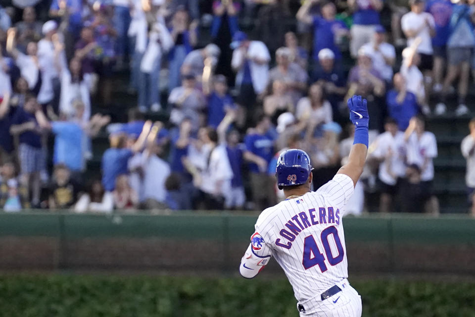 Chicago Cubs' Willson Contreras salutes the fans in the bleachers as he celebrates his grand slam off Pittsburgh Pirates relief pitcher Bryse Wilson during the first inning of a baseball game Monday, May 16, 2022, in Chicago. (AP Photo/Charles Rex Arbogast)