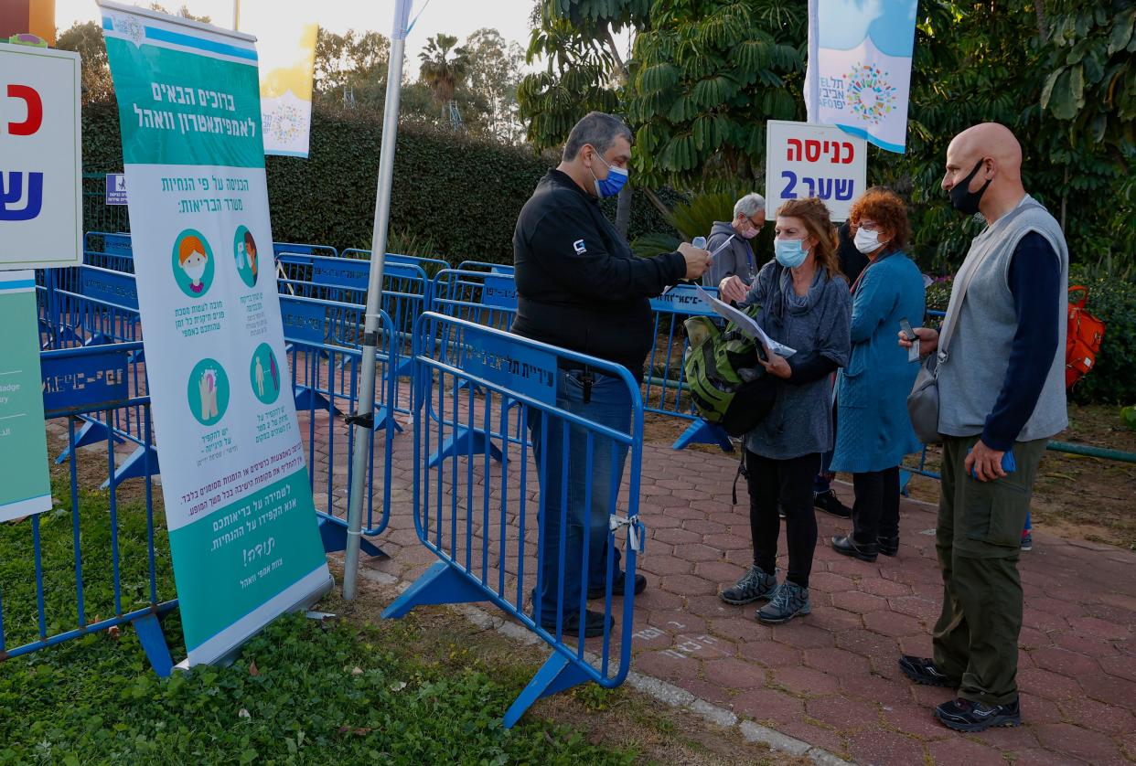 Officials checking green passes to allow entry to the concert. (Getty)