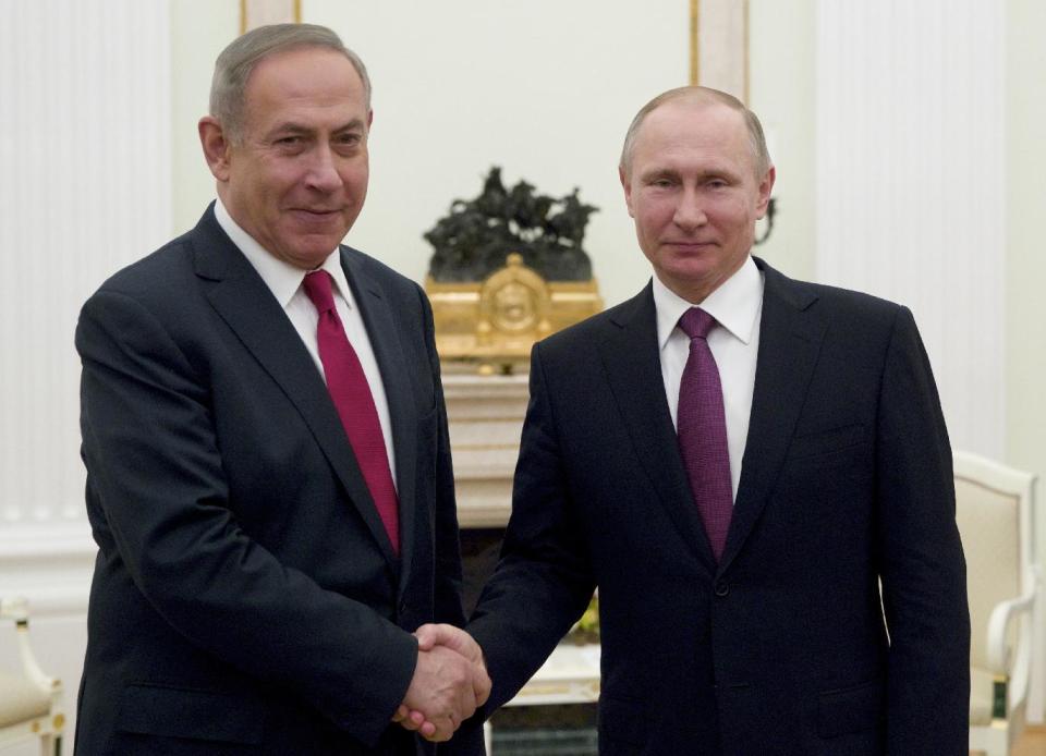 Russian President Vladimir Putin, right, shakes hands with Israeli Prime Minister Benjamin Netanyahu in Moscow, Russia on Thursday, March 9, 2017. Israel's prime minister is set to visit Moscow for talks with Russian President Vladimir Putin about security issues stemming from Iran's presence in neighbouring Syria. (AP Photo/Pavel Golovkin, pool)