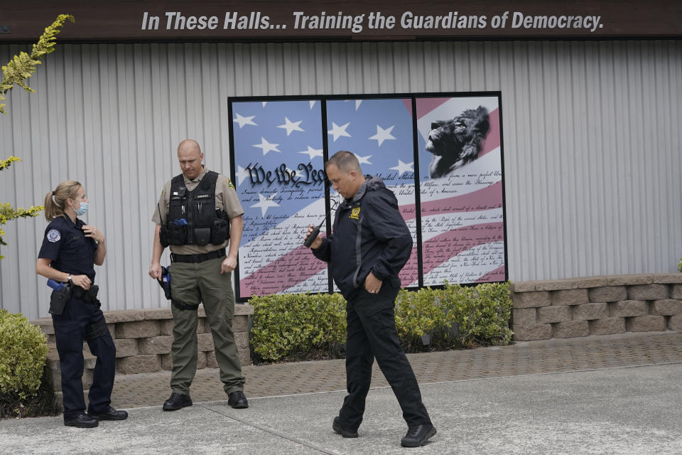 Ken Westphal, right, an officer with the Lacey Police Dept. and an instructor at the Washington state Criminal Justice Training Commission, works with cadets LeAnne Cone, of the Vancouver Police Dept., and Kevin Burton-Crow, right, of the Thurston Co. Sheriff's Dept., during a training exercise Wednesday, July 14, 2021, in Burien, Wash. Washington state is embarking on a massive experiment in police reform and accountability following the racial justice protests that erupted after George Floyd's murder last year, with nearly a dozen new laws that took effect Sunday, July 25, but law enforcement officials remain uncertain about what they require in how officers might respond — or not respond — to certain situations, including active crime scenes and mental health crises. (AP Photo/Ted S. Warren)