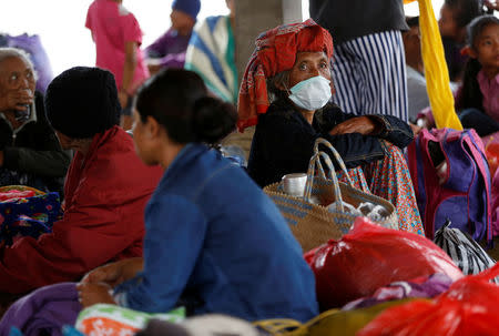 An elderly woman that evacuated a village located along the slopes of Mount Agung, a day after the volcano's alert status was raised to the highest level, rests at a temporary shelter in Rendang, on the resort island of Bali, Indonesia September 23, 2017. REUTERS/Darren Whiteside