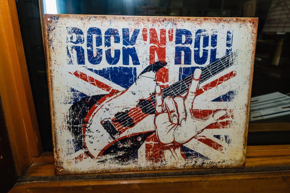 A tin rock 'n' roll sign adorns a broadcast booth at the WBTC radio studio in Uhrichsville.