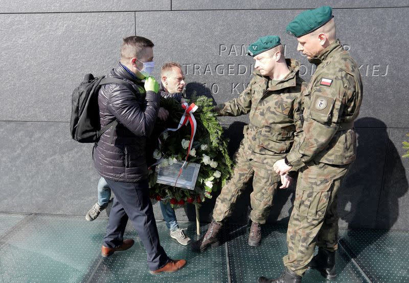 Soldiers stop people protesing in front of the monument to the victims of the Smolensk air disaster