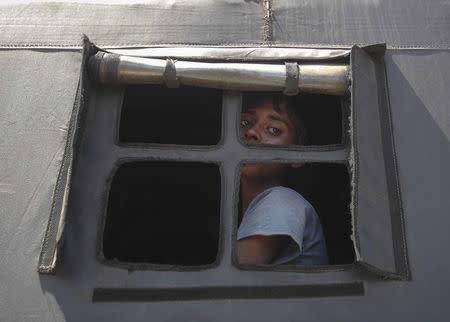 A Rohingya migrant who arrived today by boat looks out the window of a police truck before departing with others to a temporary shelter, in Idi Rayeuk, in Indonesia's Aceh Province May 20, 2015. REUTERS/YT Haryono