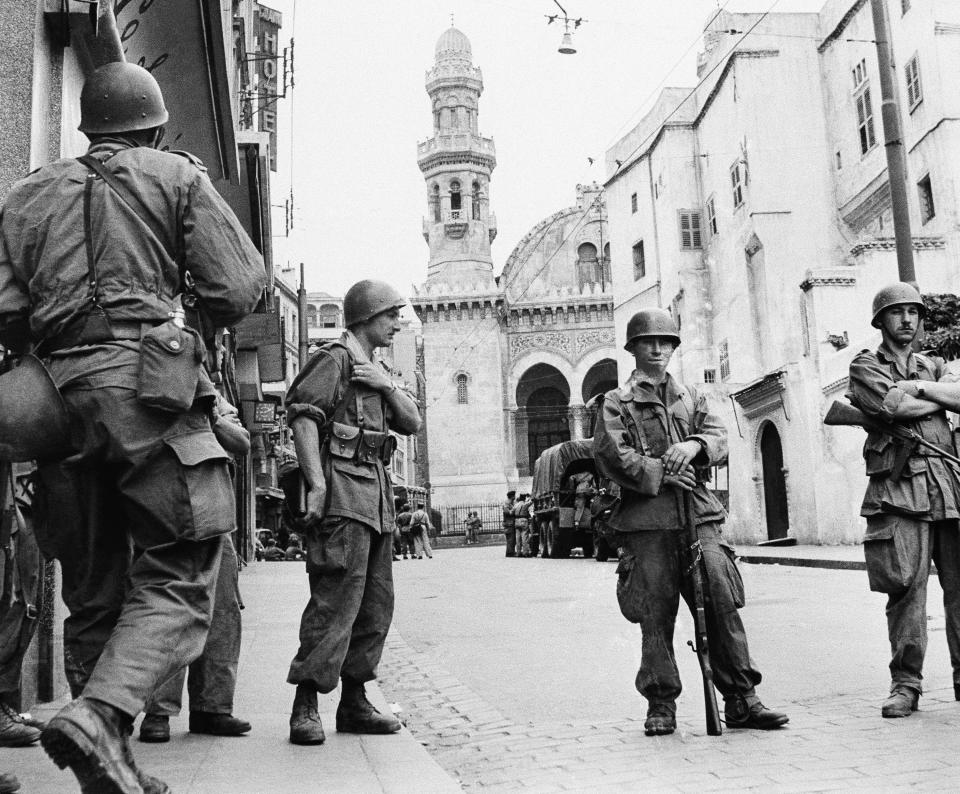 FILE - In this May 27, 1956 file photo, French troops seal off Algiers' notorious casbah, 400-year-old teeming Arab quarter. French President Emmanuel Macron has met with four grandchildren of an Algerian independence fighter to tell them that Ali Boumendjel had been tortured and assassinated at the hands of French soldiers in 1957, taking another step in his effort at reconciling France with its colonial past and offering anew an outstretched hand to Algeria, France's crown jewel in 132 years of occupation. (AP Photo, File)