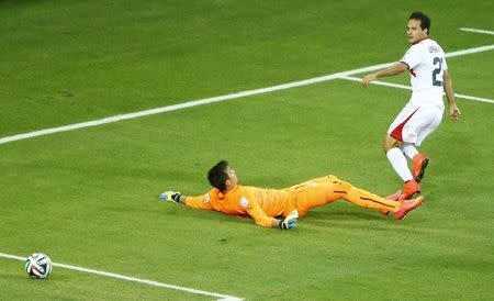 Costa Rica's Marco Urena (in white) scores a goal next to Uruguay's goalkeeper Fernando Muslera during their 2014 World Cup Group D soccer match at the Castelao arena in Fortaleza, June 14, 2014. REUTERS/Mike Blake