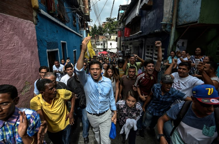 The opposition's candidate for governor for the state of Miranda, Carlos Ocariz (C), greets supporters in Caracas as Venezuela holds regional elections on October 15, 2017