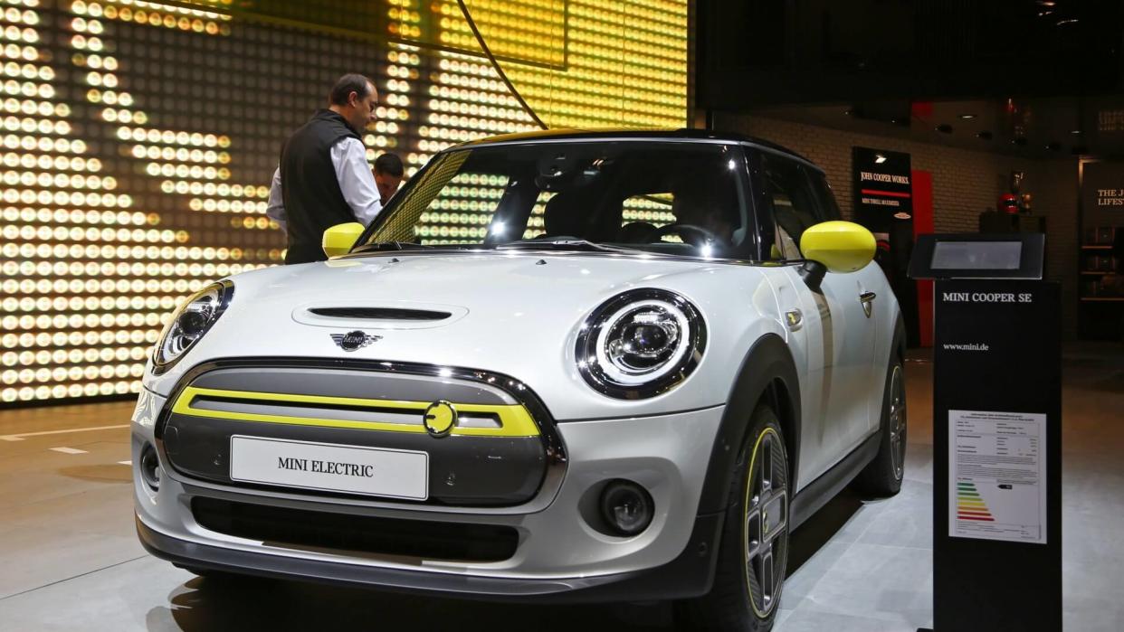 Mandatory Credit: Photo by ALEX EHLERS/EPA-EFE/Shutterstock (10406001ho)A visitor inspects a Mini Cooper SE Electric car on display at the International Motor Show IAA in Frankfurt Main, Germany, 10 September 2019.
