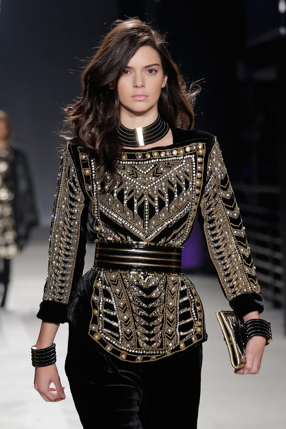 <p>Walking the runway at Balmain x H&M, Jenner looks like a rock ‘n’ roll legend with voluminous medium-length waves and pink lip gloss. <i>(Photo: Getty Images)</i><br></p>