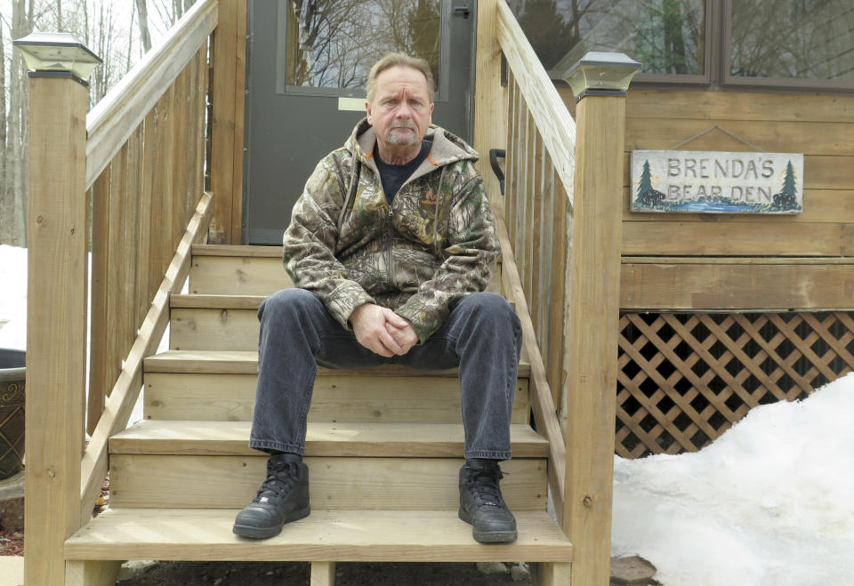 In this April 10, 2019 photo, Wayne Sankey sits on the front steps of his Lakewood, Wis. home where he is the neighbor of Raymand Vannieuwenhoven, who authorities say is the suspect in a cold-blooded 43-year-old cold case murder. The news of Vannieuwenhoven's arrest hit Sankey, 68, like a thunderbolt. Prosecutors said they used DNA and genetic genealogy to connect Vannieuwenhoven to the 1976 killings of a young couple, David Schuldes and Ellen Matheys. (AP Photo/Ivan Moreno)