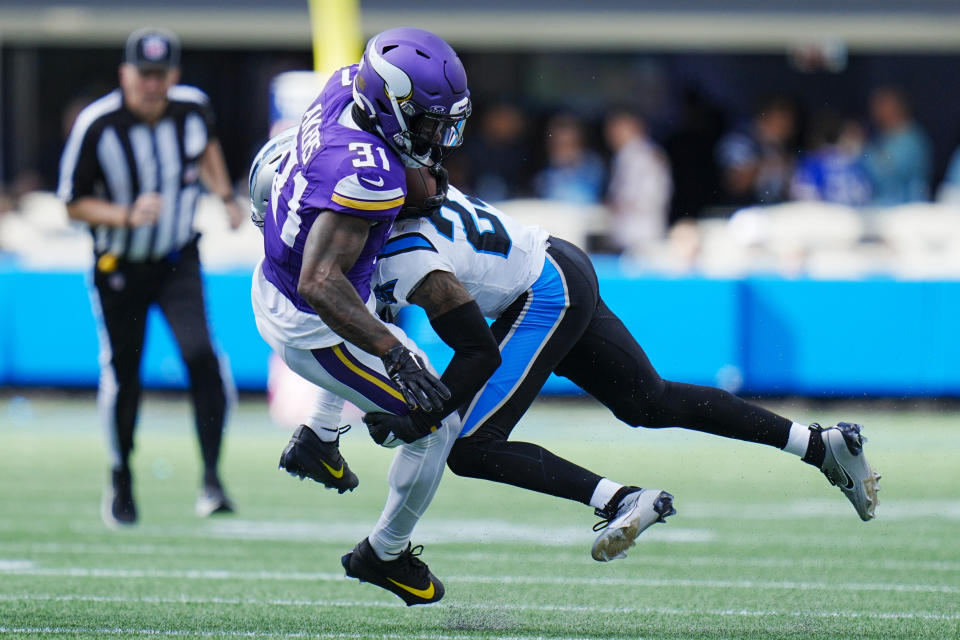 Minnesota Vikings running back Cam Akers is tackled by Carolina Panthers cornerback CJ Henderson during the second half of an NFL football game Sunday, Oct. 1, 2023, in Charlotte, N.C. (AP Photo/Rusty Jones)