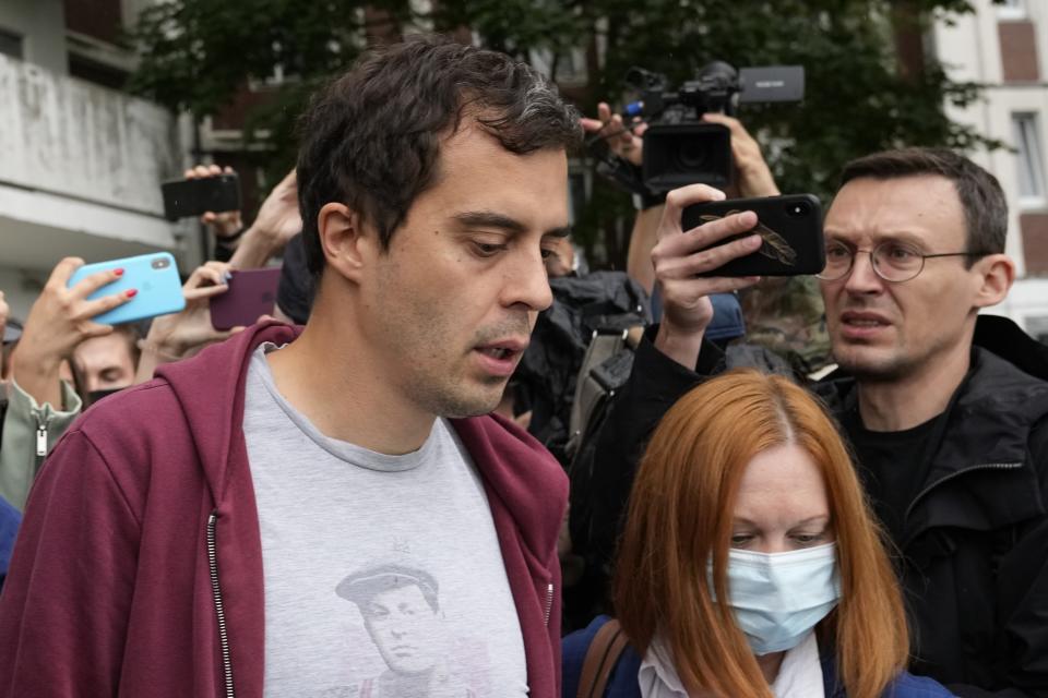 Roman Dobrokhotov, chief editor of The Insider walks surrounded police officers and journalists, in Moscow, Russia, Wednesday, July 28, 2021. Police in Russia raided the home of the chief editor of an investigative media outlet that was recently designated as a "foreign agent," the latest step by authorities to raise pressure on independent media ahead of the country's September parliamentary election. (AP Photo/Alexander Zemlianichenko)