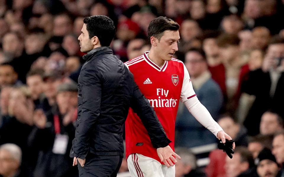 Mikel Arteta and Mesut Ozil head in opposite directions