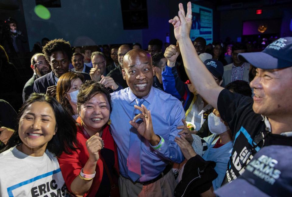 Bernard Adams, center, brother of New York Mayor Eric Adams, mingles with supporters at his brother's election night party June 22, 2021, in New York. Mayor Adams seeks approval from city ethics officers to hire his brother, a former New York police officer, as the head of his security detail.