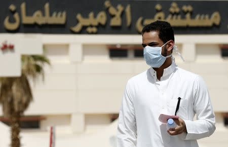 A man wearing a mask walks outside Prince Salman bin Abdulaziz hospital, in Riyadh in this June 6, 2014 file photograph. When Saudi Arabia announced last week that it had found 113 more cases of the deadly Middle East Respiratory Syndrome (MERS), it didn't just force a rethink of the threat the virus poses, it exposed dangerous institutional failings. REUTERS/Faisal Al Nasser/Files