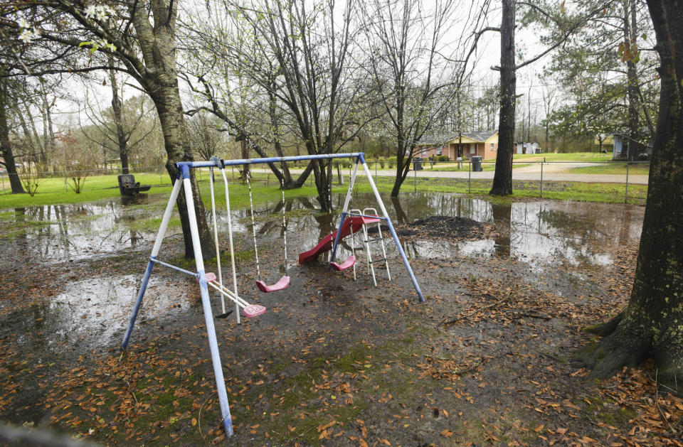 FILE - Heavy rains flood the front yard of Lowndes County resident Charlie Mae Holcombe, Feb. 21, 2019, in Hayneville, Ala. Holcombe keeps her grandchildren out of the front yard because she fears contamination from the failing wastewater sanitation system at her home. (AP Photo/Julie Bennett, file)