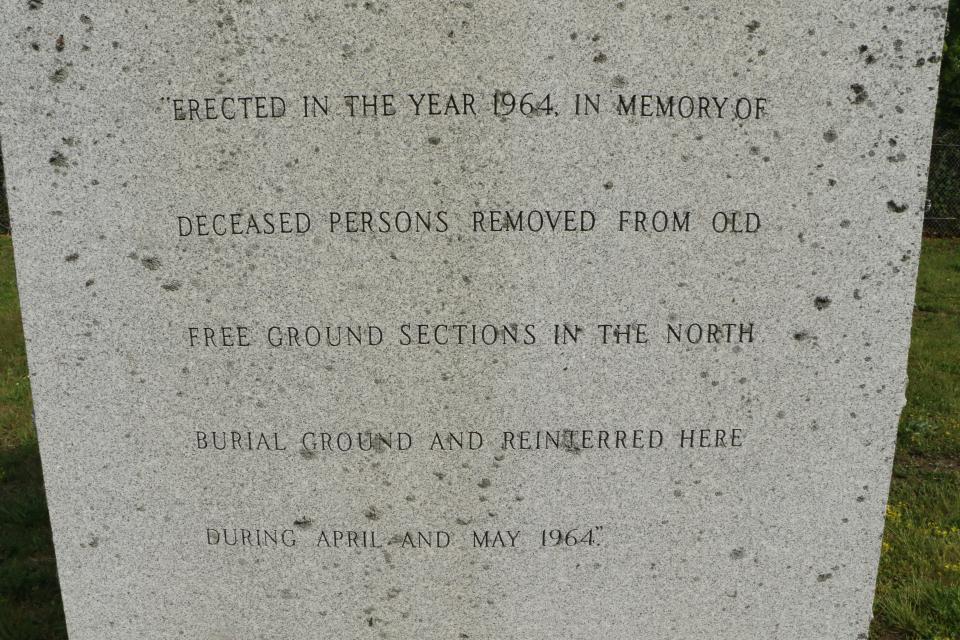 An inscription on a monument in the Potter's Field section of Providence's North Burial Ground honors Herbert Johnson and 2,000 others who were dug up and reburied in mass graves when Interstate 95 was built through the old "Free Ground" of paupers' graves.