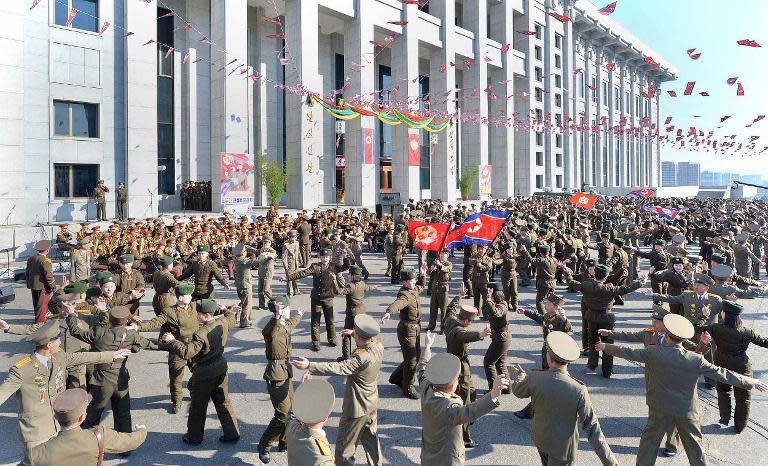 North Korean soldiers dance after casting their votes in an election in Pyongyang on March 9, 2014