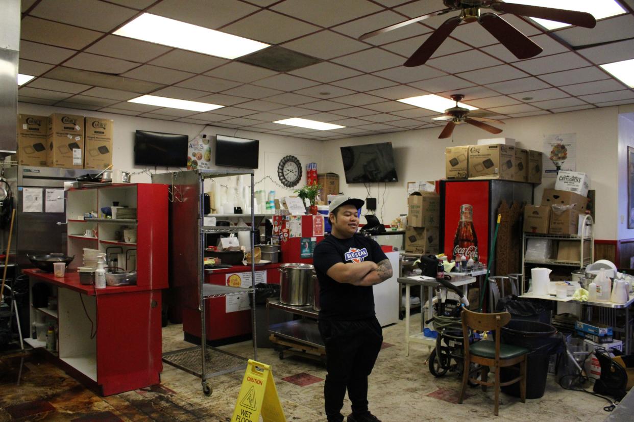 Thai Time owner Jay Pomanee stands in the middle of his ruined restaurant.