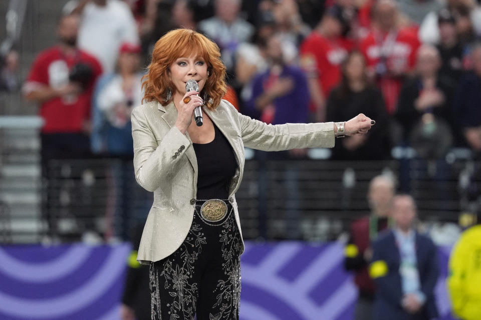 Reba McIntyre singing on the field