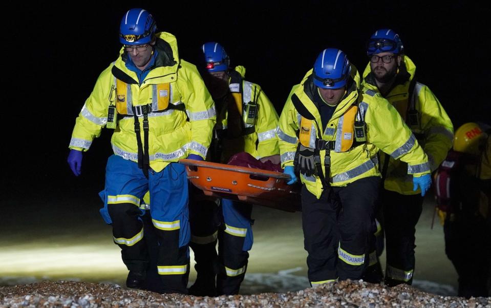 A person is carried ashore on a stretcher at Dungeness, Kent