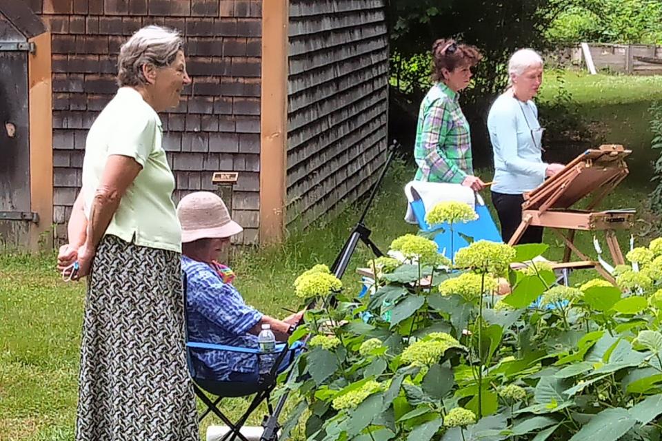 Participants of the plein air event draw pictures of a wildflower garden in 2020.