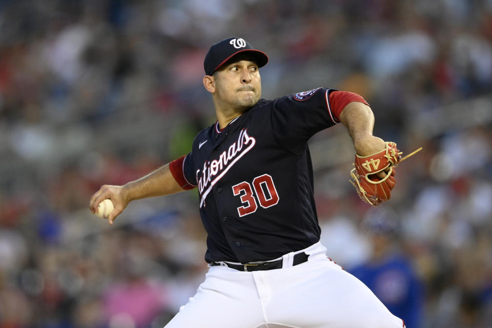 Washington Nationals starting pitcher Paolo Espino winds up during the fourth inning of the team's baseball game against the Chicago Cubs, Friday, July 30, 2021, in Washington. (AP Photo/Nick Wass)