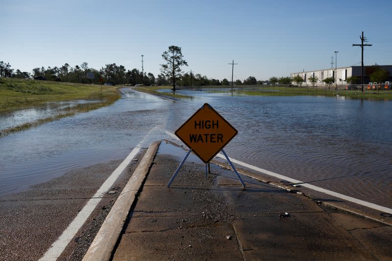 A sign is posted along a flooded street after Hurricane Delta, in Lake Charles